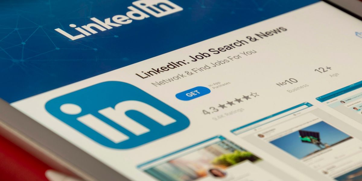 LinkedIn app open on a tablet screen against a blue background