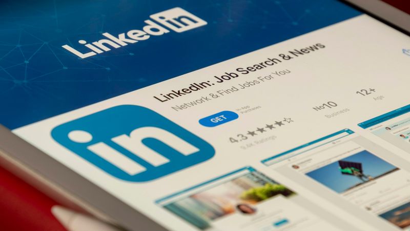 LinkedIn app open on a tablet screen against a blue background