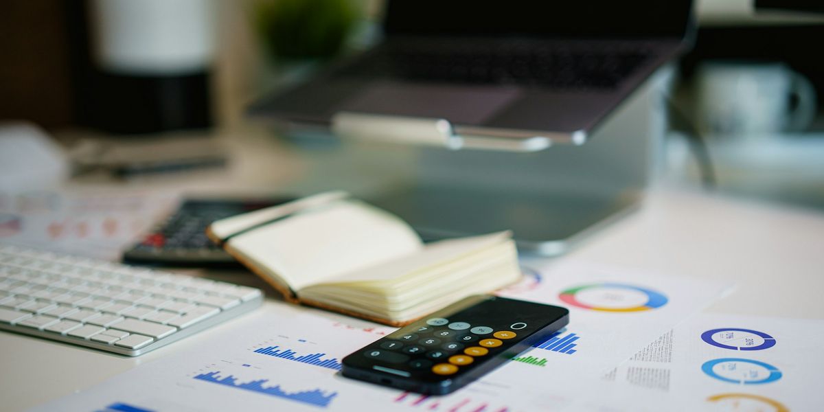 Notebook, calculator and budget charts on a desk